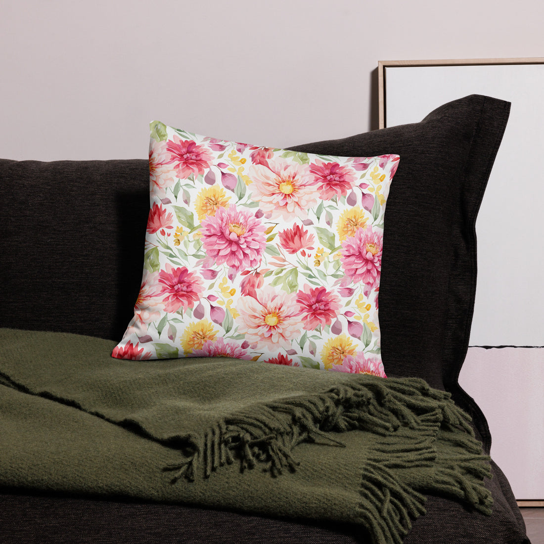 Luxurious pillow with pink peonies and green leaves on a soft fabric background.