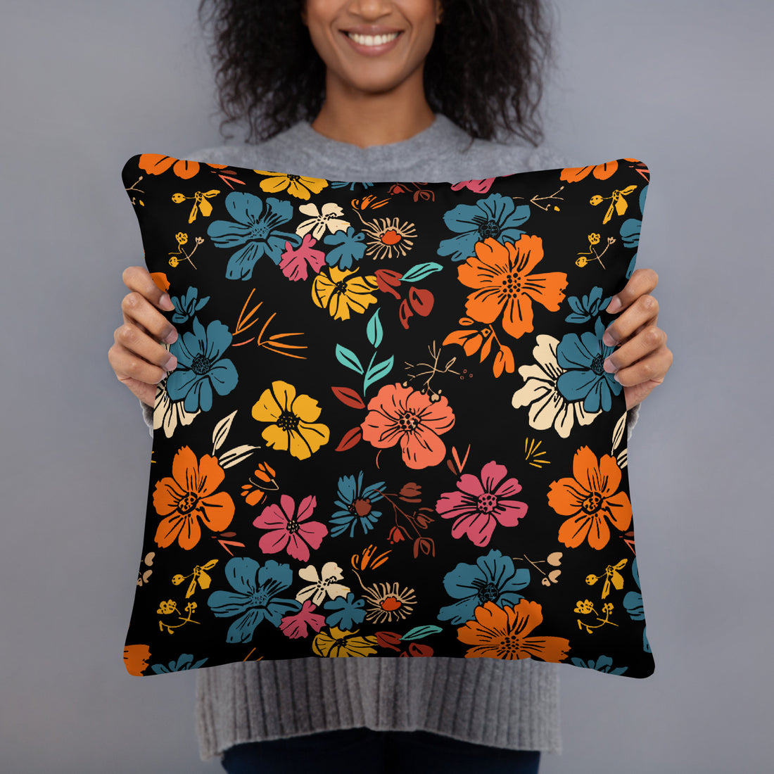 Colorful floral accent pillow featuring vibrant designs on a black backdrop.