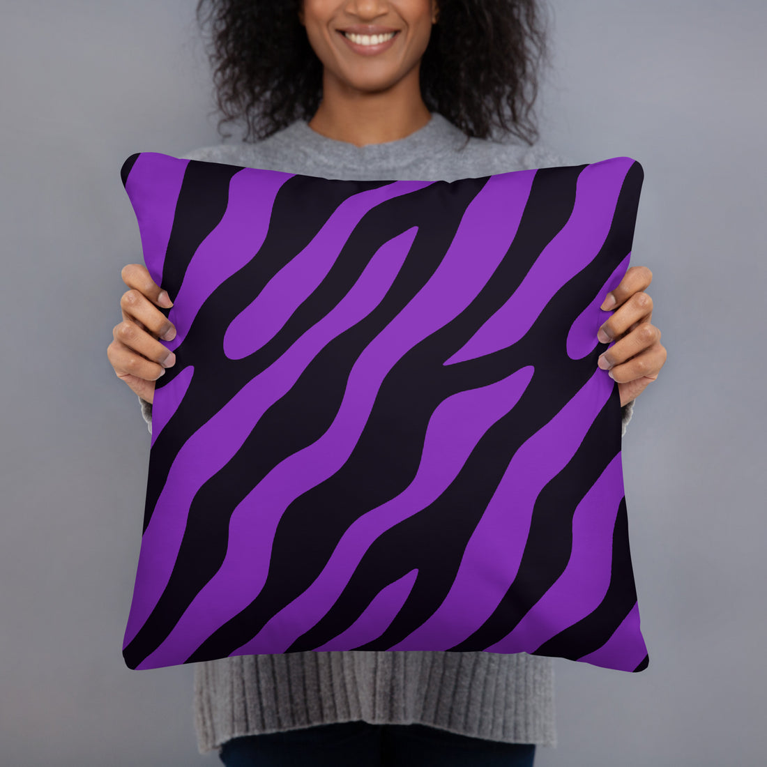 Purple zebra print pillow with hidden zipper held by a smiling woman.