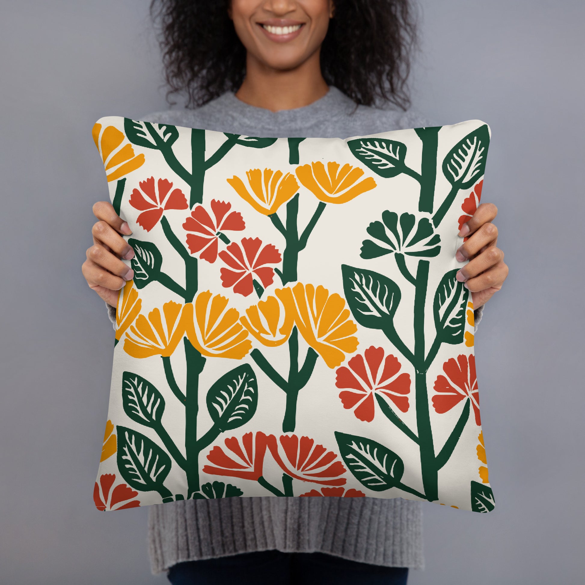 Pillow with yellow and red floral design featuring bold blossoms and green leaves, perfect for winter decor.