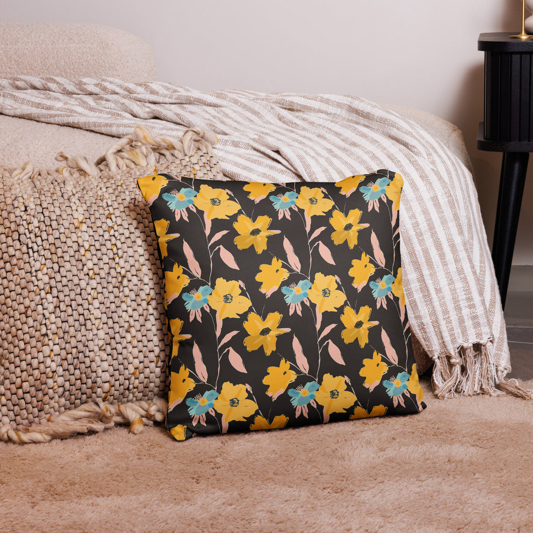 Vintage floral decorative pillow with yellow and teal blooms against a dark background, adding a cozy touch to winter decor.