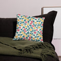 Vibrant floral pillow with red, yellow, green botanical design on polyester fabric.