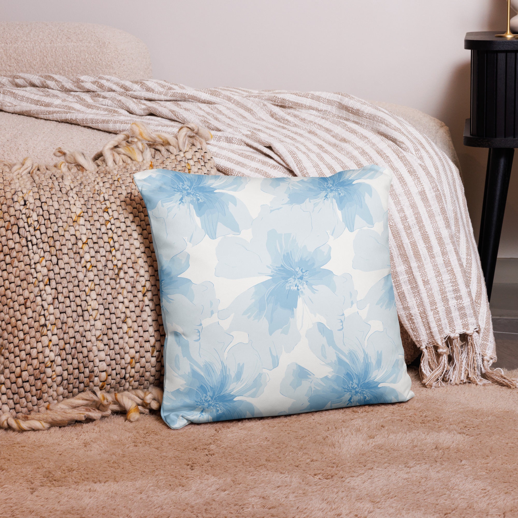 Pastel blue floral decorative pillow on a cozy living room setting, enhancing holiday and winter ambiance.