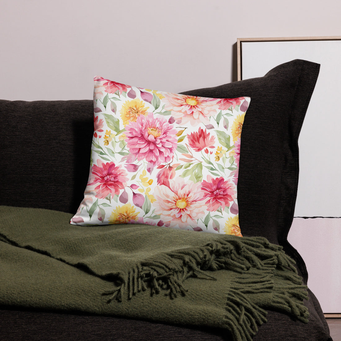 Luxurious pillow with pink peonies and green leaves on a soft fabric background.