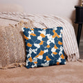 Nature-inspired pillow with abstract pattern in blue, orange, and cream, set against cozy decor.