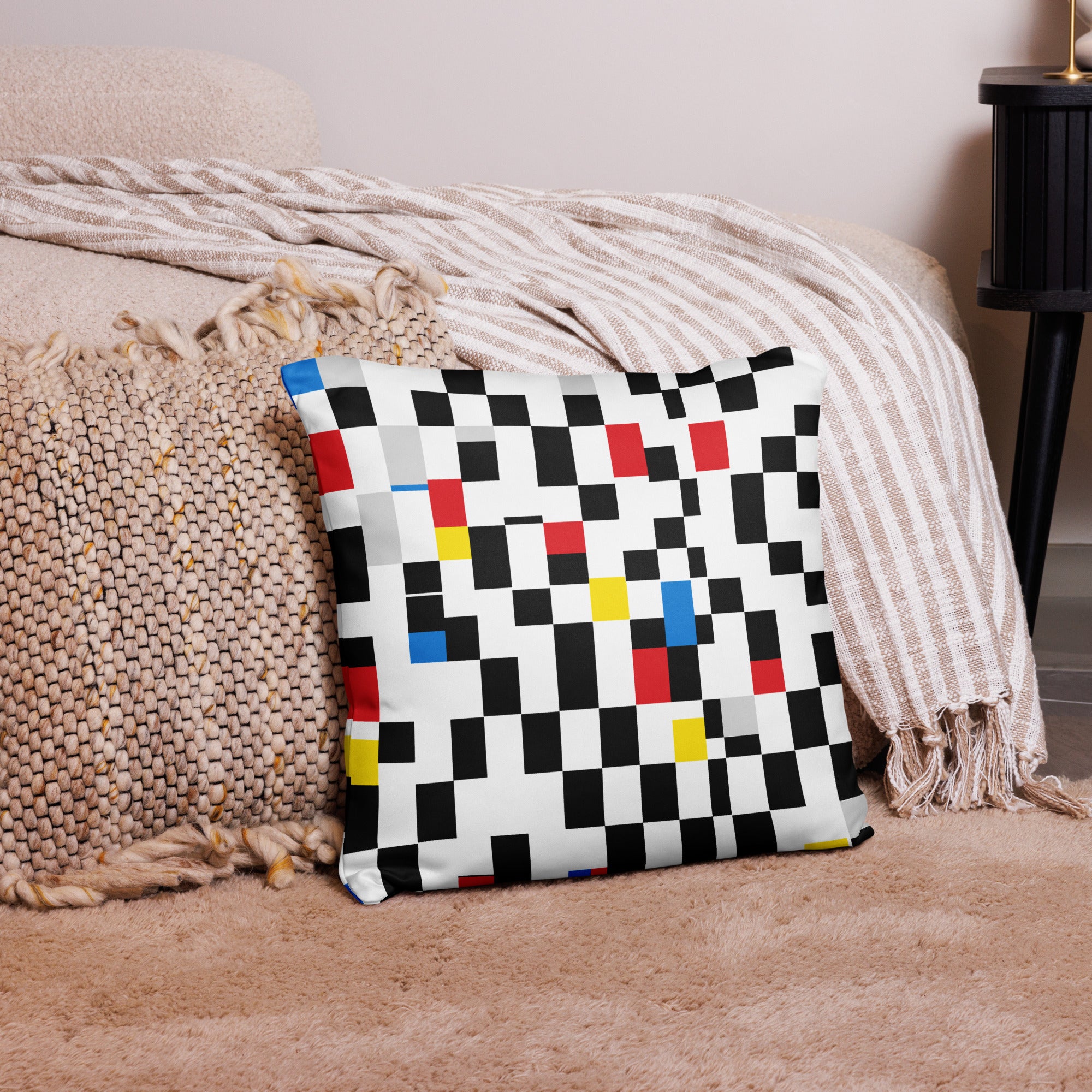 Decorative pillow featuring a Mondrian-inspired checkerboard design with bold red, blue, yellow accents, and hidden zipper.