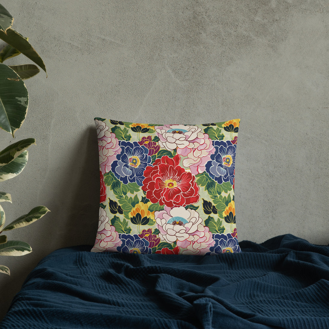 Floral accent pillow with vibrant red, blue, pink, and green peony design on a soft, machine-washable polyester case.