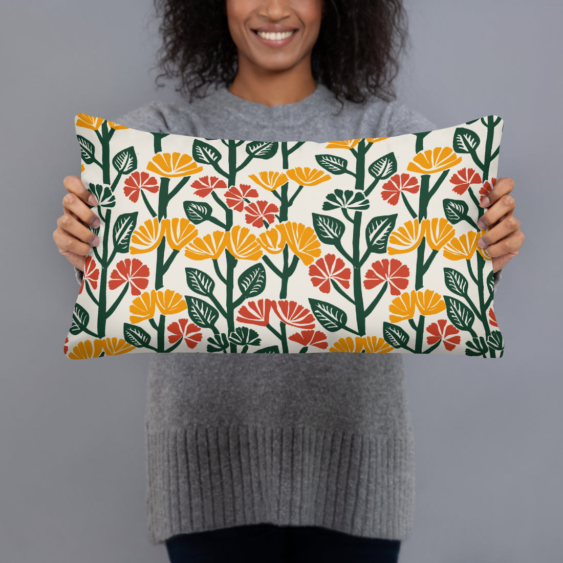 Pillow with yellow and red floral design featuring bold blossoms and green leaves, perfect for winter decor.