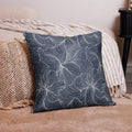 Navy blue floral accent pillow featuring white line designs, adding elegance to a cozy living space.