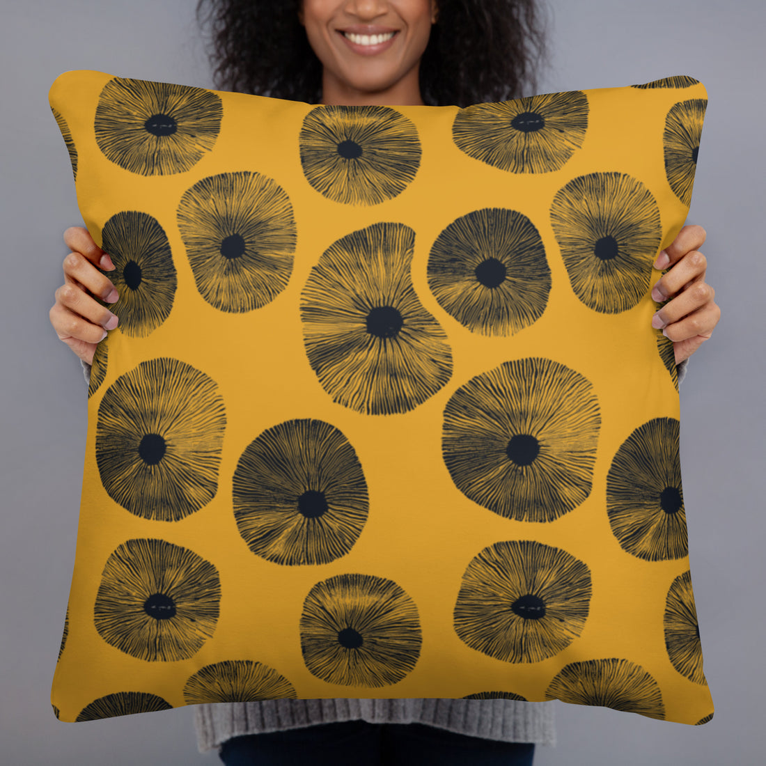 Artisan Floral Print Pillow with yellow background and black floral design in a woman's hands