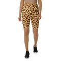 Giraffe print high-waisted biker shorts worn by a model with black sneakers.