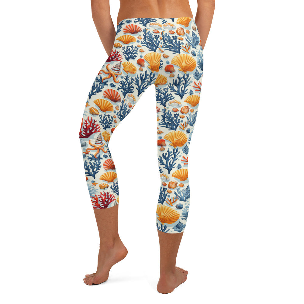 Capri leggings with sea coral and shell print in coral, orange, and blue, soft and stretchy fabric suitable for winter fashion.