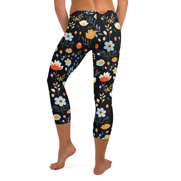 Back view of capri leggings with vibrant floral print in orange, white, and muted blues, showcasing a unique winter fashion design.