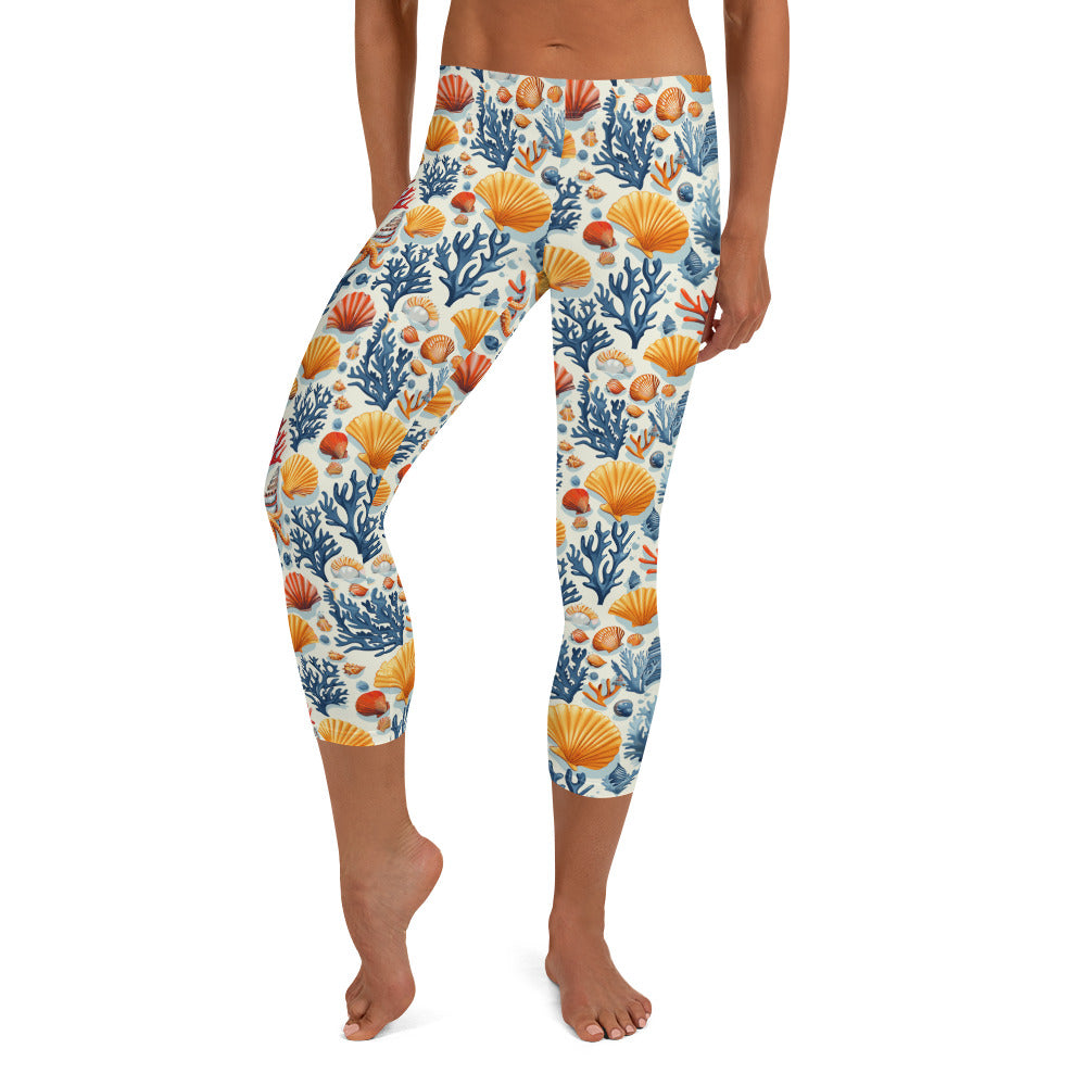 Capri leggings with sea coral and shell print in coral, orange, and blue, soft and stretchy fabric suitable for winter fashion.