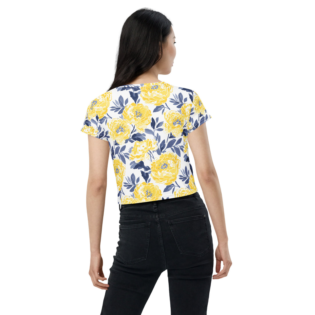 Model wearing a crop tee with vibrant yellow peony floral print against a white background, perfect for winter fashion.