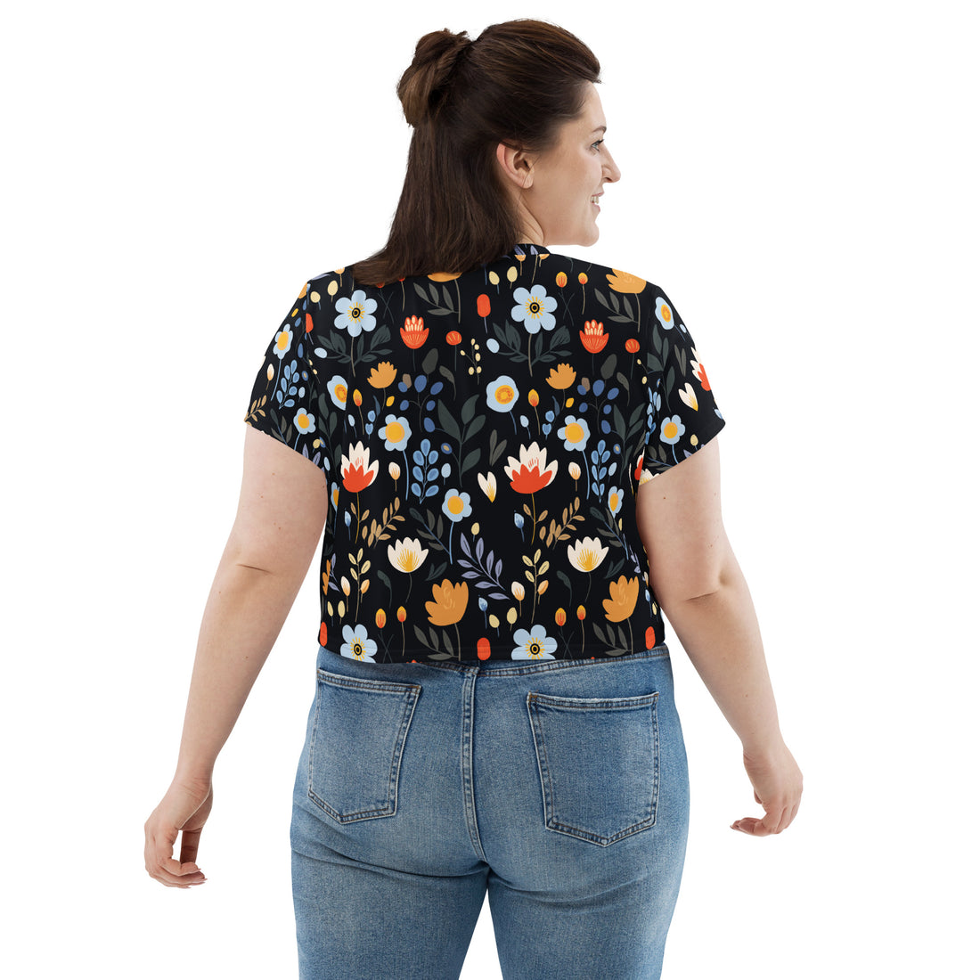 A crop tee featuring vibrant tulips and daisies on a black background, perfect for winter fashion and holiday styling.