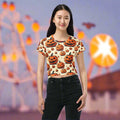 Halloween Pumpkin Print Crop Tee featuring a vibrant design with whimsical pumpkins against a cream background, perfect for festive celebrations.