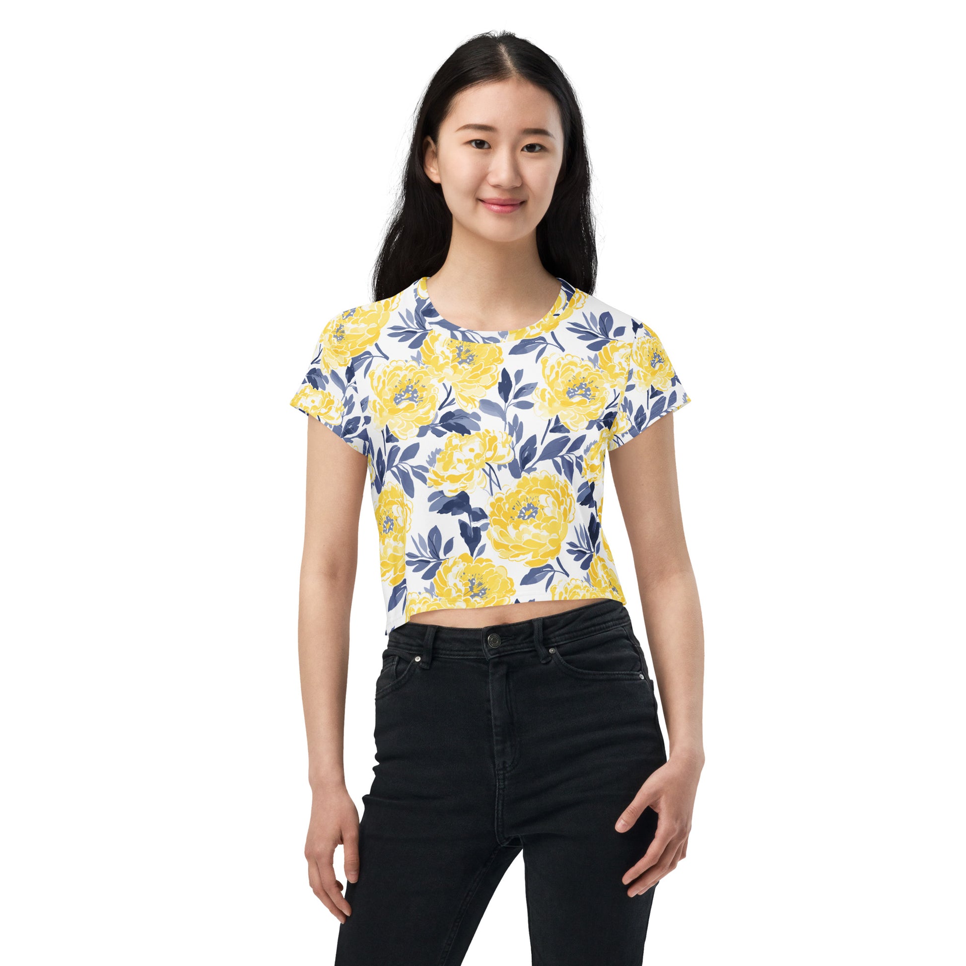 Model wearing a crop tee with vibrant yellow peony floral print against a white background, perfect for winter fashion.