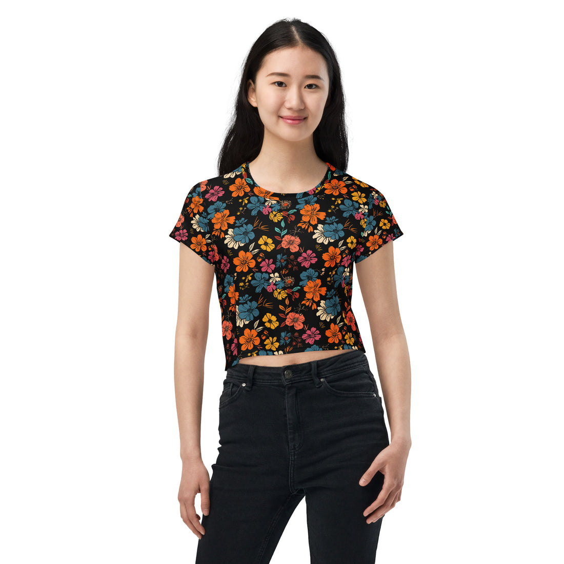 Woman wearing a vibrant floral black crop tee with red, blue, and orange blooms, suitable for stylish winter fashion.