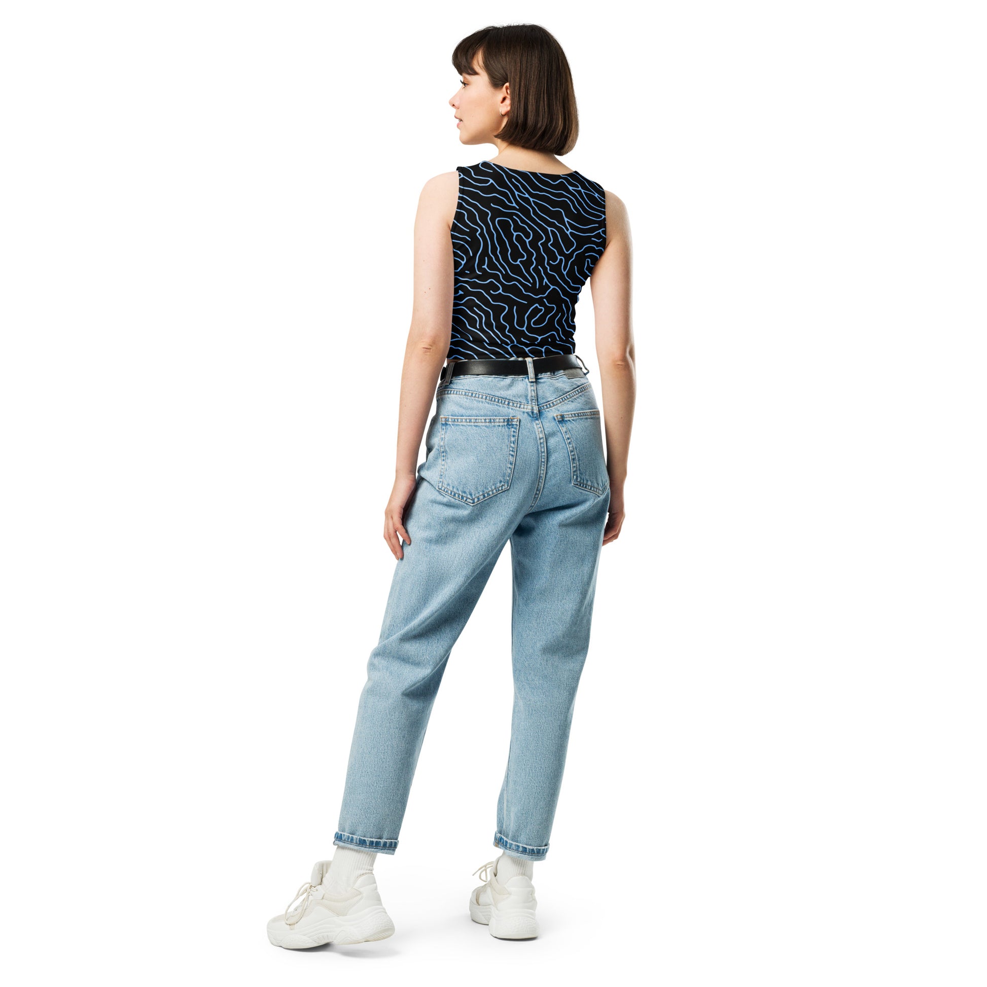 Stylish black crop top with unique white wave design, model wearing jeans and sneakers.