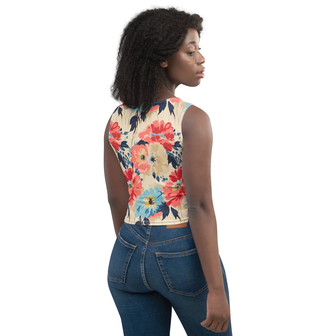 Woman wearing a floral crop top with vibrant red and blue flowers, and a body-hugging fit.