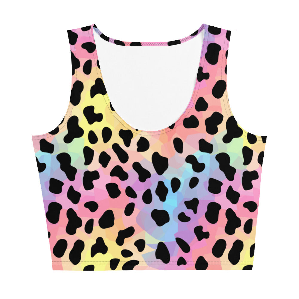 Vibrant leopard print crop top with a body-hugging fit, featuring colorful spots, worn by a woman in a gym setting.