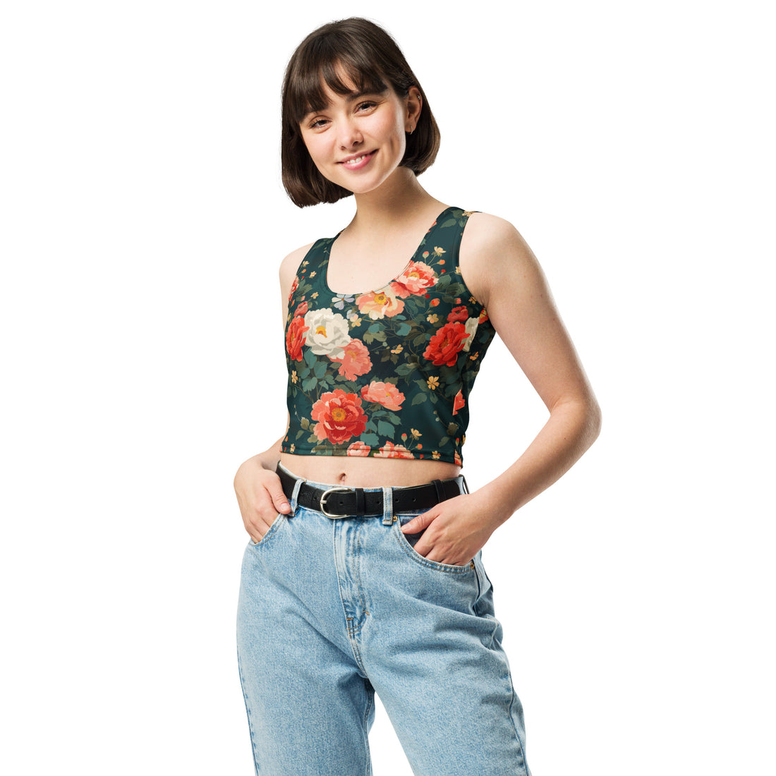 Model wearing a crop top with a winter rose floral design featuring vibrant red and cream roses on a deep green background, paired with light blue jeans.