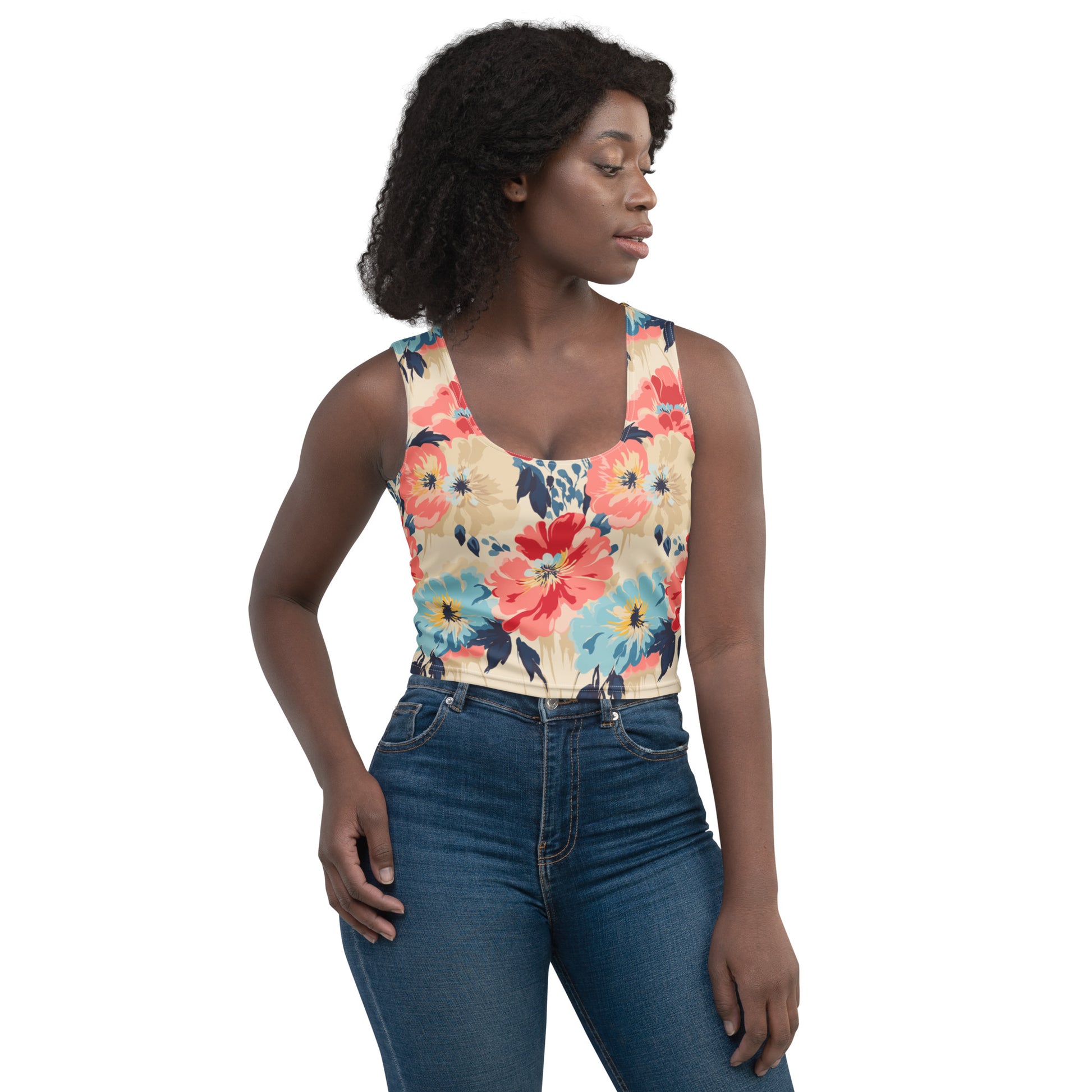 Woman wearing a floral crop top with vibrant red and blue flowers, and a body-hugging fit.