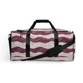 Stylish duffle bag with maroon wave pattern against cream background.