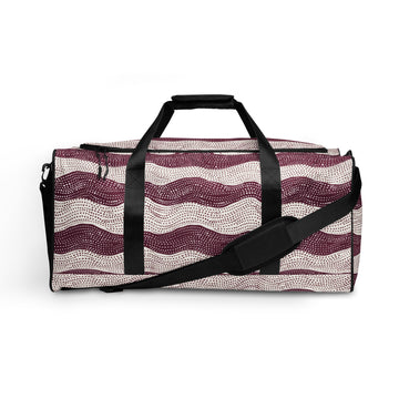 Stylish duffle bag with maroon wave pattern against cream background.