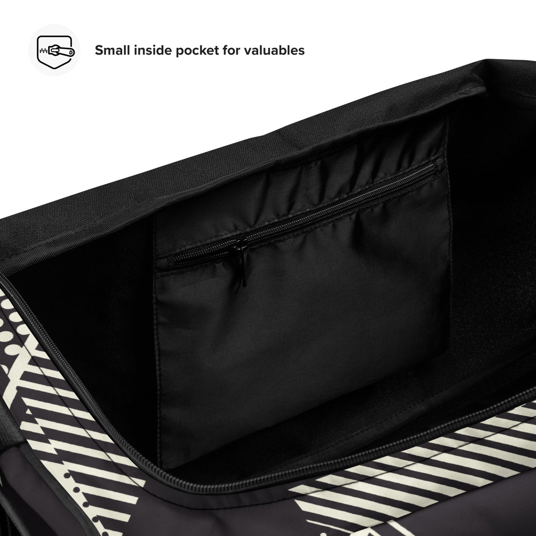 Geometric print duffle bag in black and cream, featuring adjustable strap and multiple pockets.