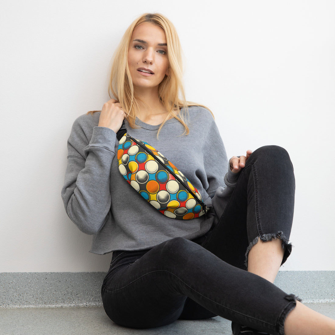 Colorful graphic fanny pack featuring a playful circle pattern in bright colors on a black background.