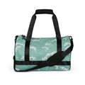 Wave pattern gym bag in turquoise with black straps and padded handles.