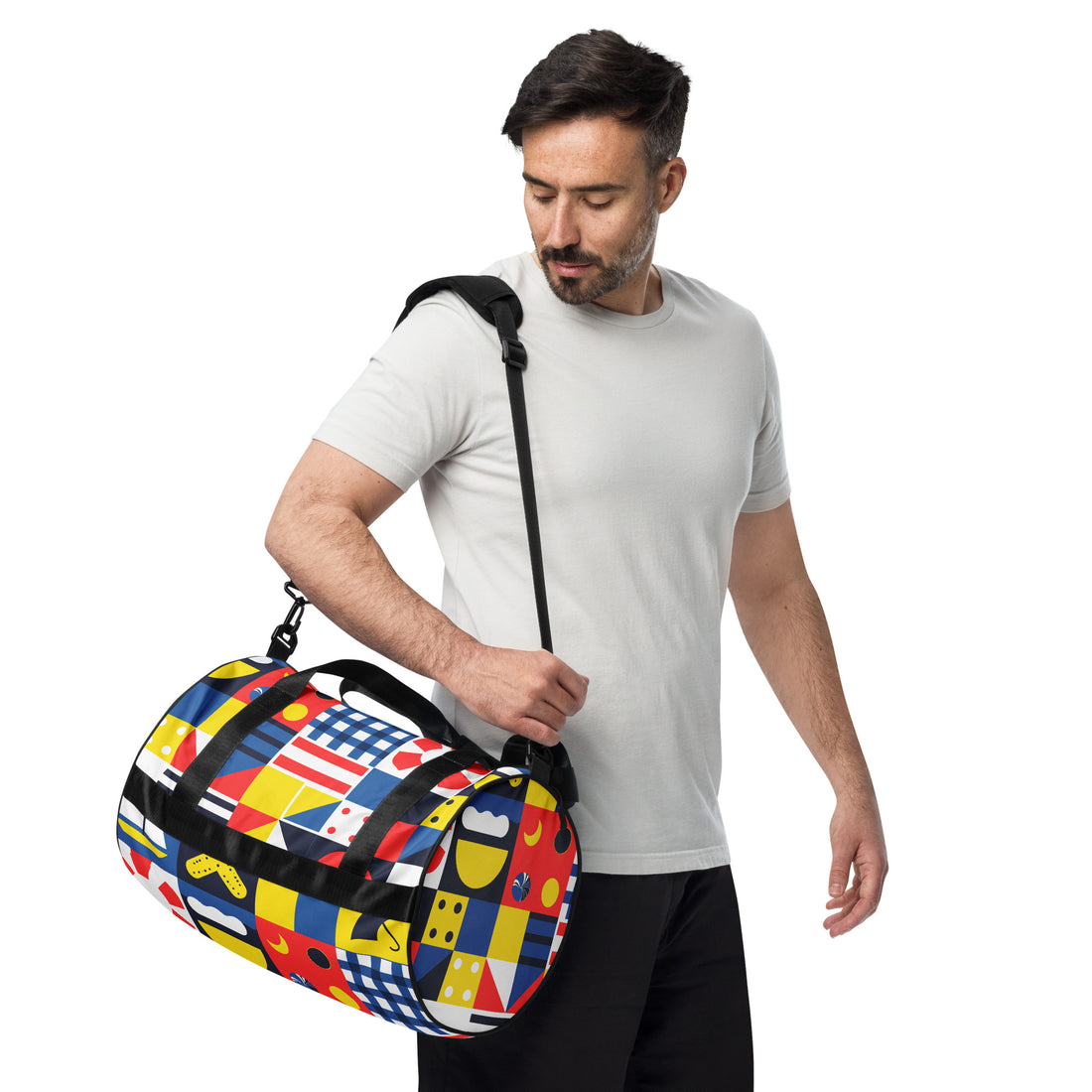 Vibrant geometric print gym bag featuring colorful patterns in blue, red, yellow, and black with padded handles.