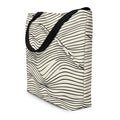 Large tote bag featuring a stylish wavy line pattern in black on a cream background.