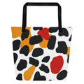 Vibrant abstract pattern large tote bag featuring bold colors including black, orange, red, and white, ideal for beach outings.