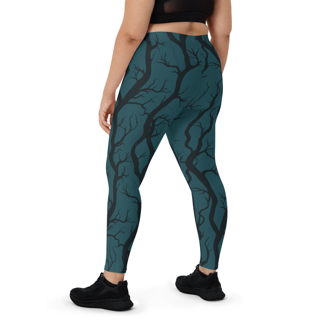 Haunting Tree Design Leggings in teal with black tree branches, model wearing casual outfit