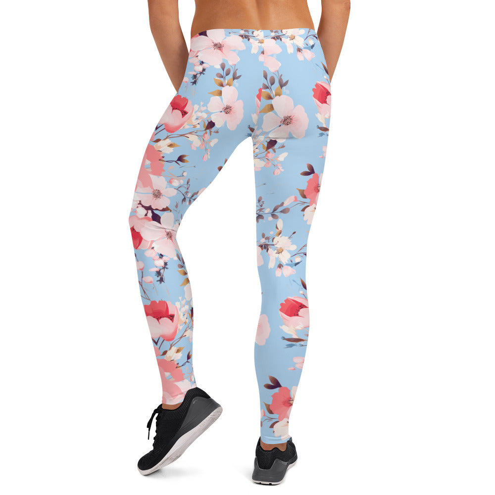 Women's leggings with a cherry blossom floral design on a light blue background, showcasing a vibrant and stylish look