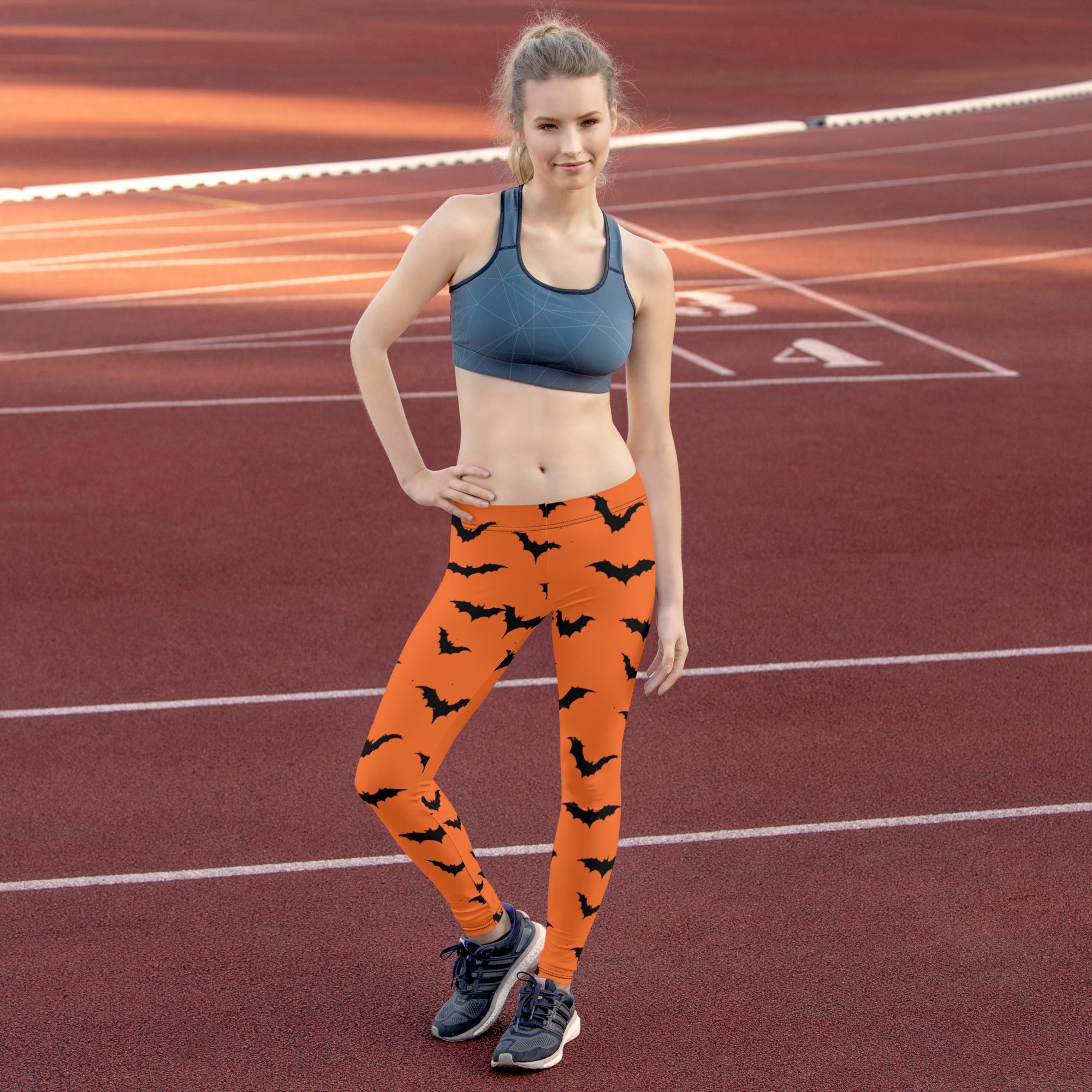 Orange leggings with black bats for women, perfect for Halloween fashion.