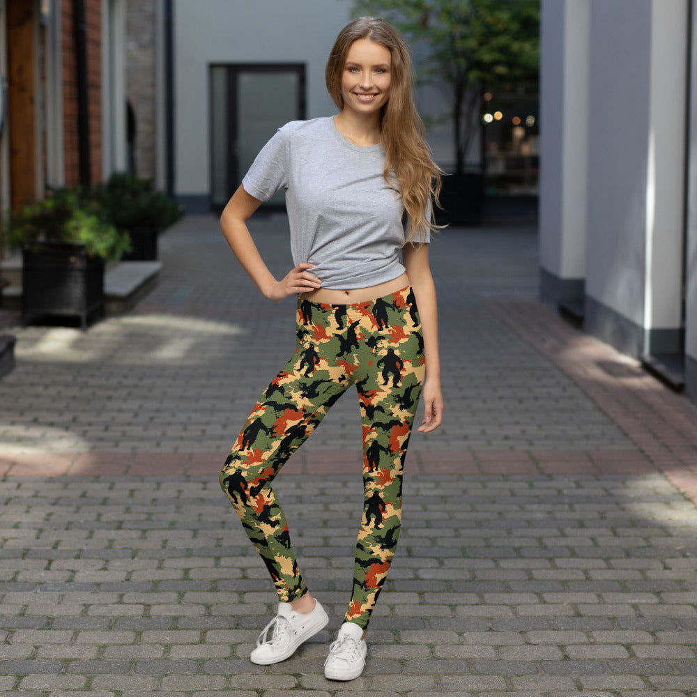 Women wearing Halloween-themed camo leggings in vibrant fall colors