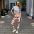 Woman wearing vibrant floral peach leggings with red and blue floral design, perfect for winter fashion. Features comfortable microfiber fabric with four-way stretch.