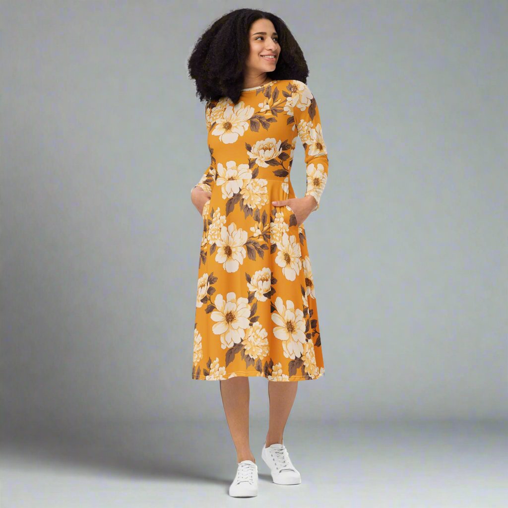 Floral midi dress in yellow with long sleeves and pockets on model.