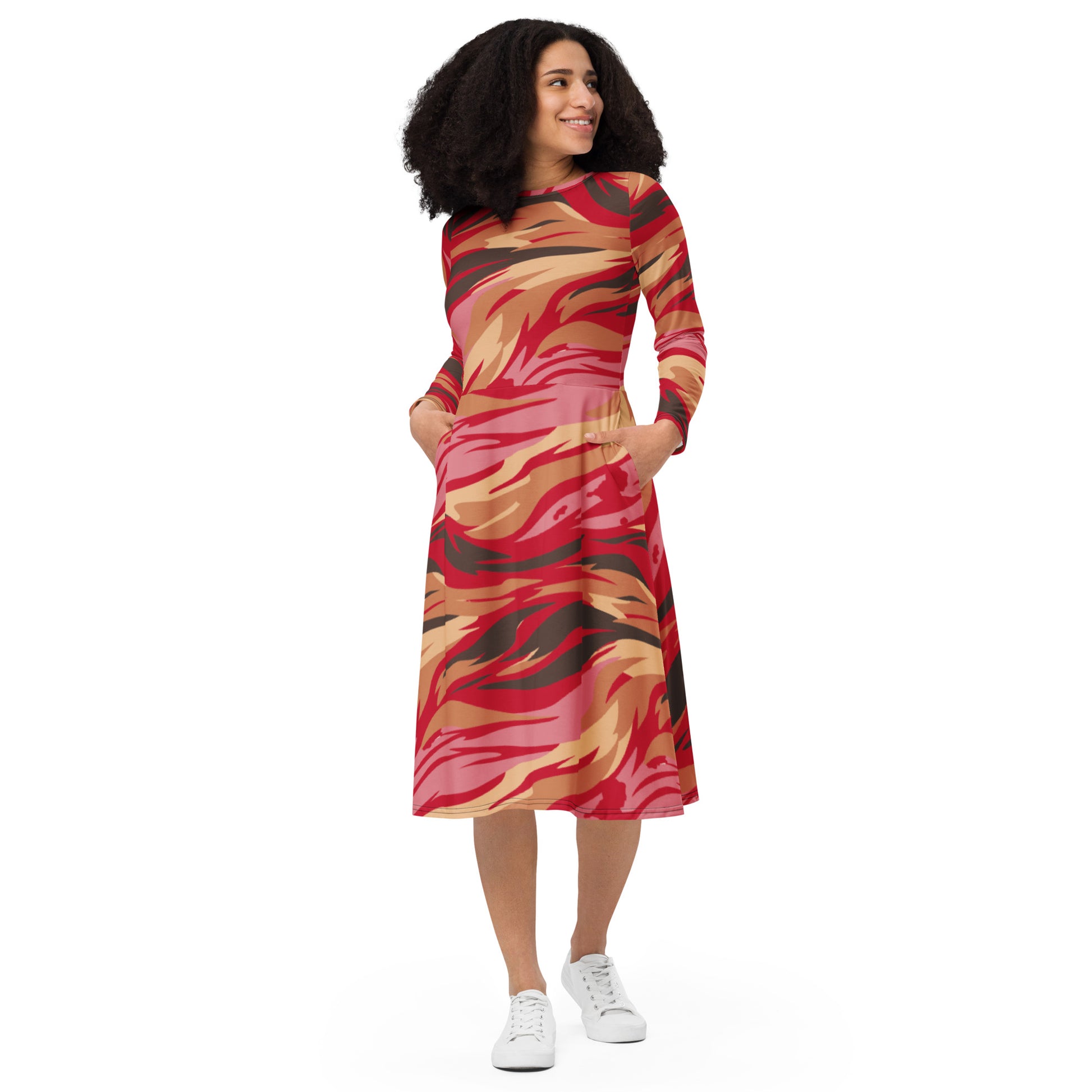 Stylish long sleeve midi dress in vibrant abstract print with pockets, featuring a fitted waist and flared skirt.