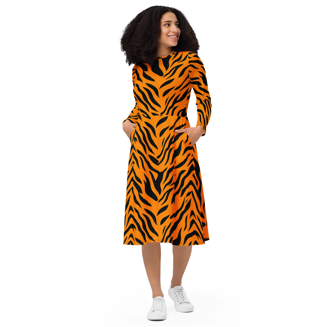 Model wearing a long sleeve midi dress with a vibrant tiger print, featuring pockets and a flared skirt.