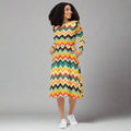 Vibrant chevron long sleeve midi dress with pockets, featuring bold colors and stylish pattern.