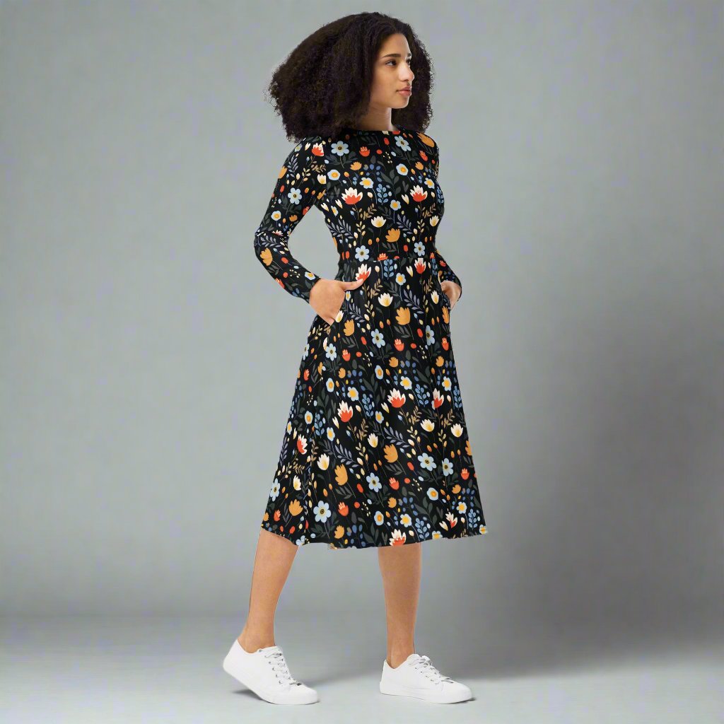 Elegant floral print long sleeve midi dress with pockets on a model against a gray background.