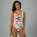 Floral one-piece swimsuit featuring vibrant pink and teal leaves, designed for a flattering fit.