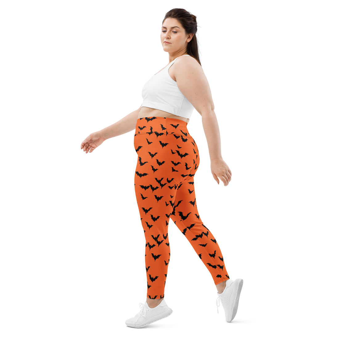 Halloween Bat Print Plus Size Leggings in orange with black bats worn by a woman in a stylish top.