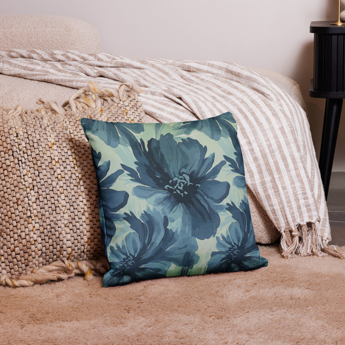 Decorative pillow with teal floral design, knitted texture, lying on cozy living room setting.