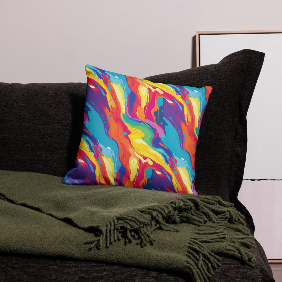 Vibrant abstract art pillow with bold blues, yellows, reds, and purples on a dark sofa, adding colorful decor to winter home.